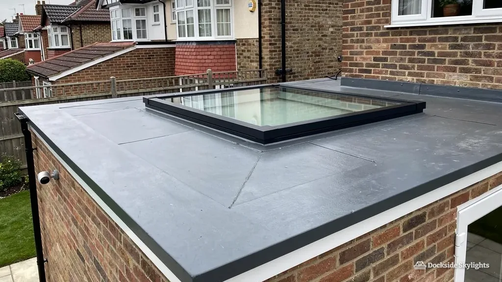 Flat rooflight on an extension roof with a row of 1930s semis beyond