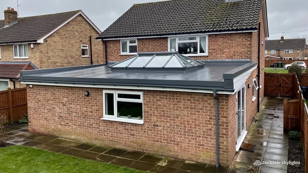 Low roof lantern on a single-storey brick extension at the back of a detached house